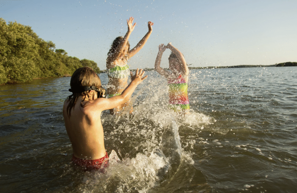 Pellea Fitness - Toronto Canada - Swimming Activity - Swimmers Splashing In Lake