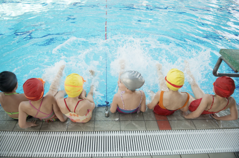 Pellea Fitness - Toronto Canada - Swimming Activity - Children Sitting on Poolside Kicking in Water