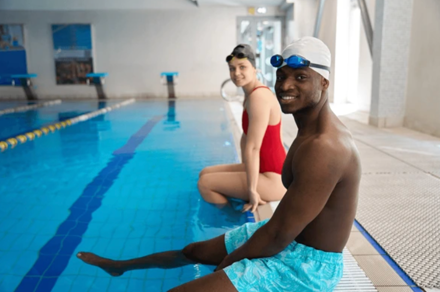 Pellea Fitness - Toronto Canada - Swimming Activity - Swimmers Sitting On Poolside