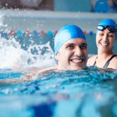 Pellea Fitness - Toronto Canada - Swimming Activity - Swim Instructor Holding Swimmer Kicking