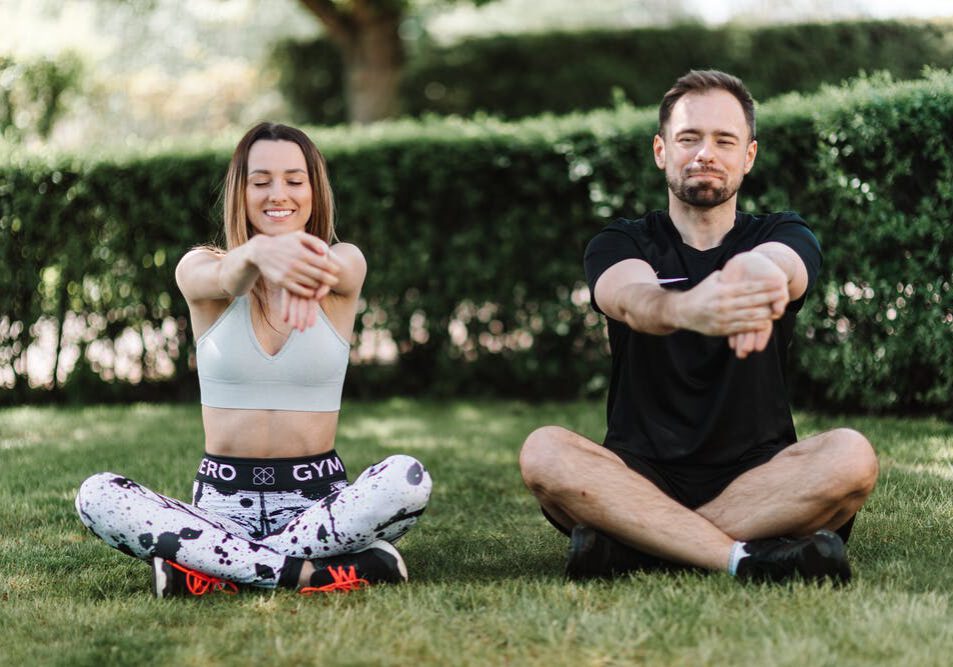 Woman and Man Doing Yoga Together